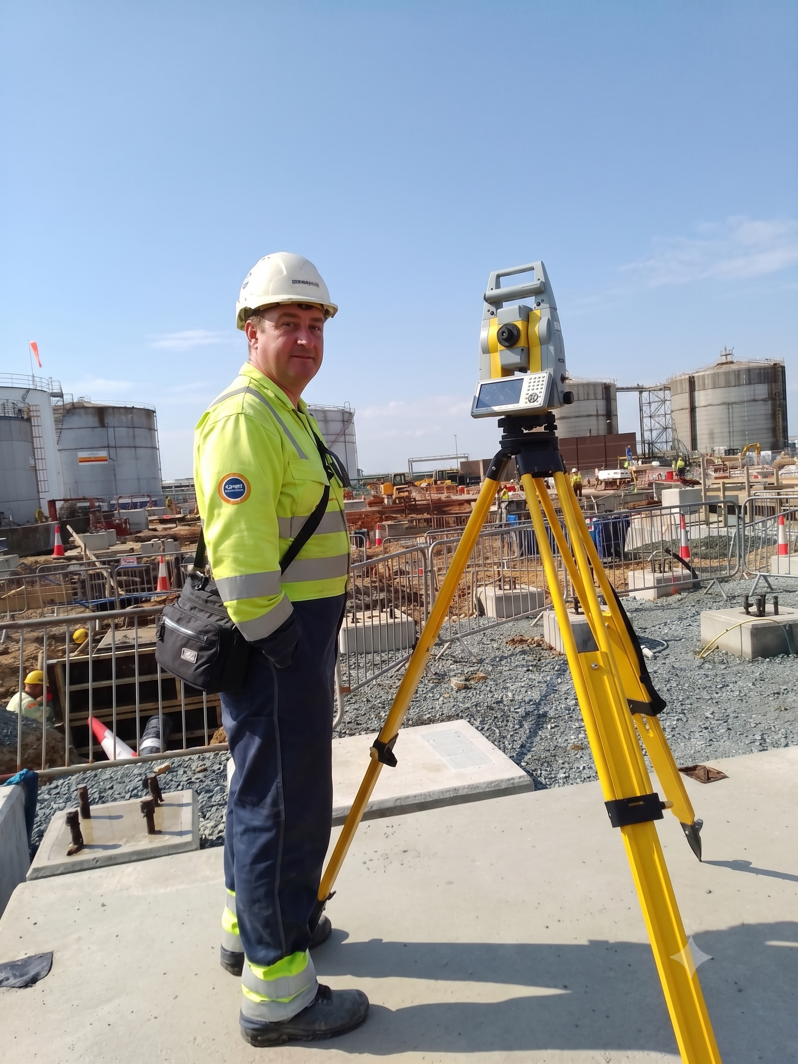 Senior site engineer using a robotic total station on a UK construction site